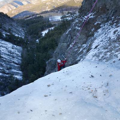 Ice Climbing long shot climbing up over ridge