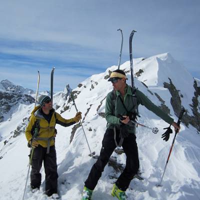 Ski touring a guide discussion with skis on the ba
