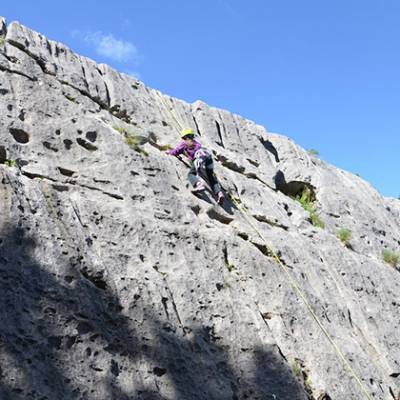 Rock Climbing kids nearly at top of block in Ceuse
