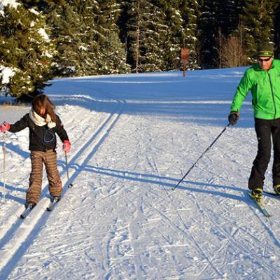 Cross Country skiing Man in green and child 