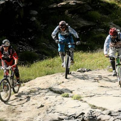 mountain biking three downhill bikers
